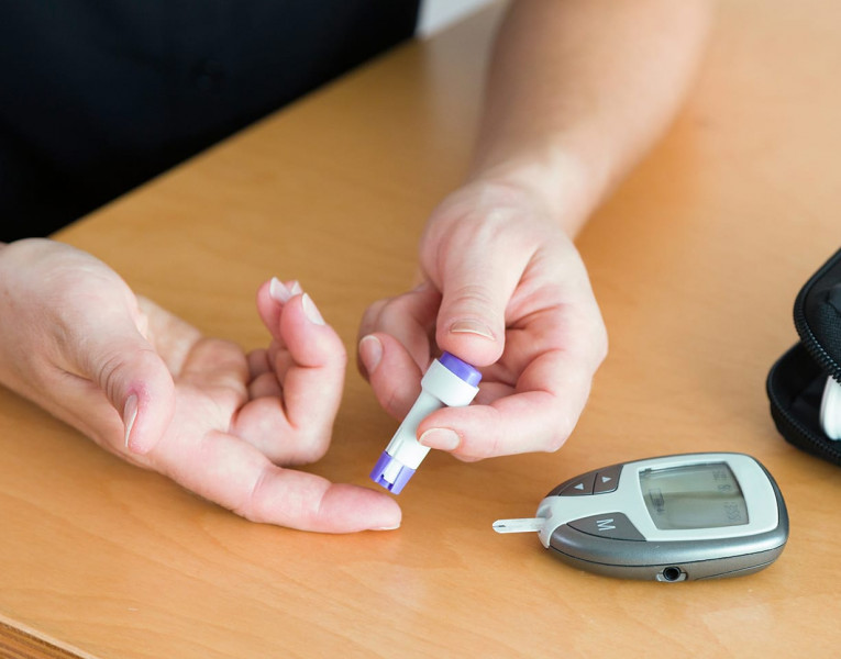 Frau macht eine Blutzuckermessung